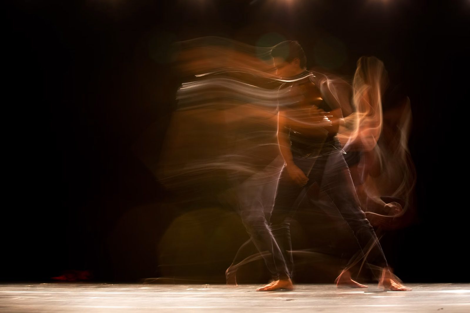 A long-exposure capture of a figure in slow, flowing motion